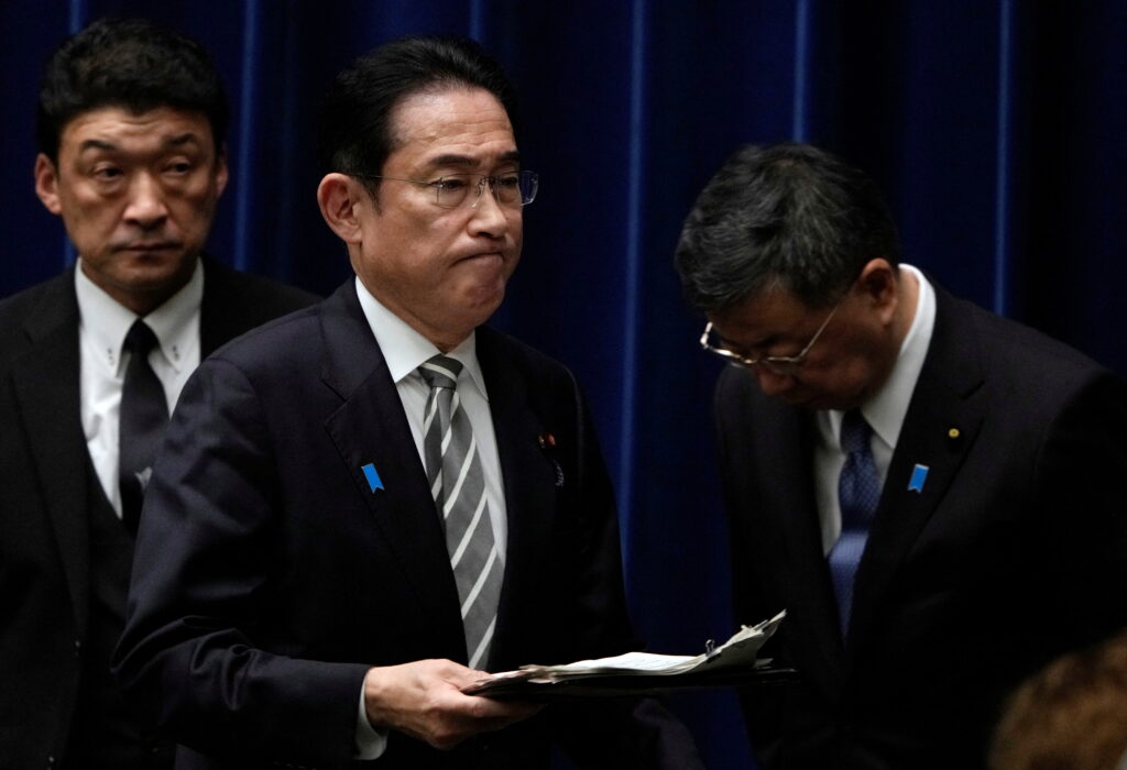 Japanese Prime Minister Fumio Kishida walks past Chief Cabinet Secretary Hirokazu Matsuno at the end of a news conference at the prime minister's office in Tokyo, Japan, 13 December 2023. Prime Minister Kishida said he will replace several ministers implicated in a political fundraising scandal (Photo: Reuters/Pool/Franck Robichon)