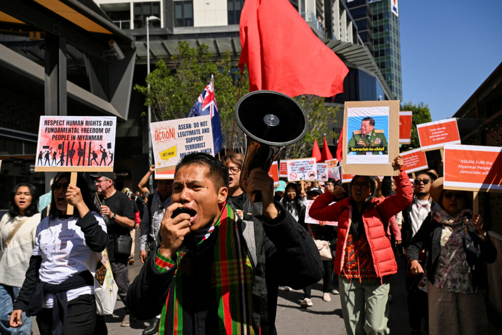 A state representative of the National Unity Government of Myanmar (NUG) speaks through a megaphone during a public rally held for the Myanmar community in Australia calling for ASEAN to not support the Myanmar Military Junta, Melbourne, Australia, 4 March 2024. (Photo: Reuters/Jaimi Joy).