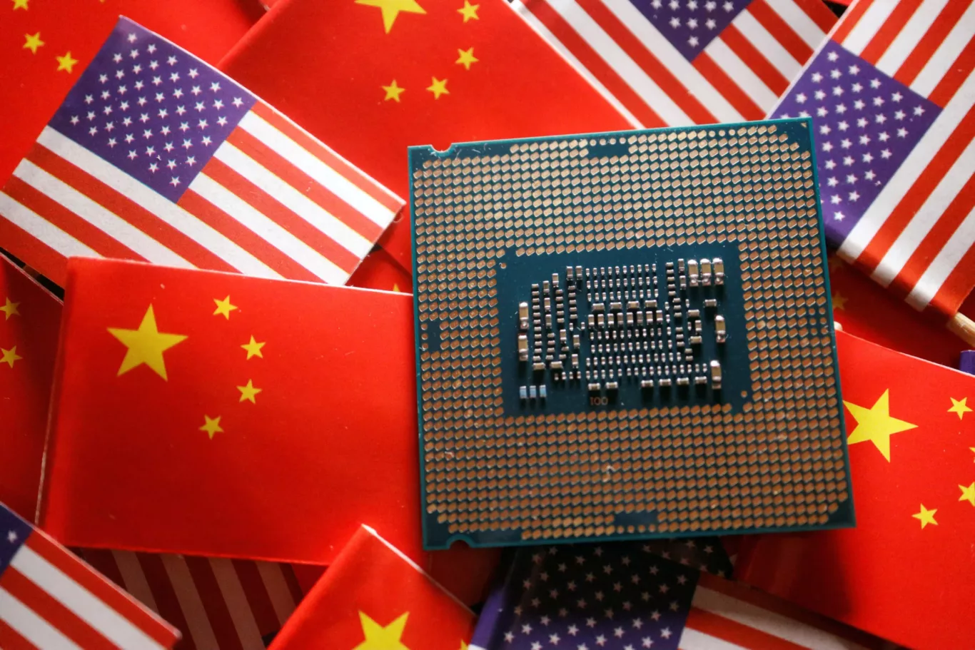 A central processing unit semiconductor chip is displayed among flags of China and the United States, 17 February 2023 (Photo: Reuters/Florence Lo).