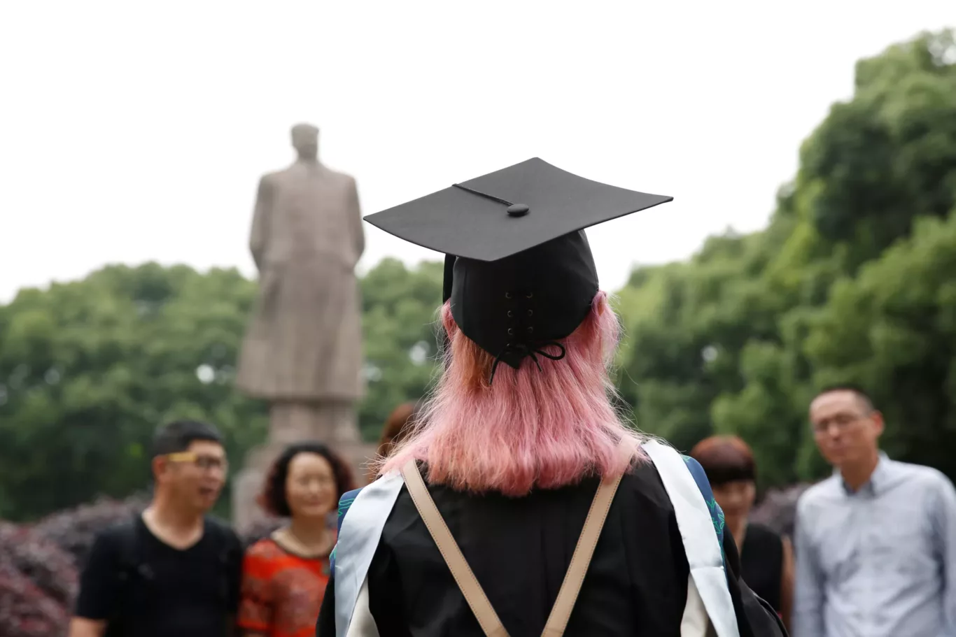 A student stands in front of the statue of Chinese leader Mao Zedong after her graduation ceremony at Fudan University in Shanghai, China, 23 June 2017. (Photo: Reuters/Aly Song)