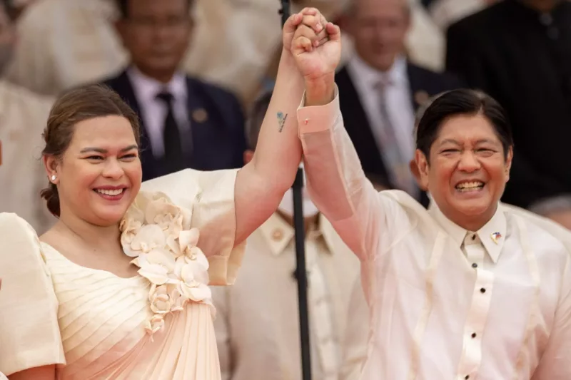 Newly-elected Vice President Sara Duterte raises the arm of newly-elected President Ferdinand 'Bongbong' Marcos Jr, during the inauguration ceremony at the National Museum in Manila, Philippines, 30 June 2022 (Photo: Reuters/Eloisa Lopez).