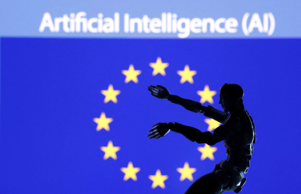AI Artificial intelligence words, miniature of robot and EU flag are seen in this illustration taken 21 December 2023 (Photo: Reuters/Dado Ruvic).