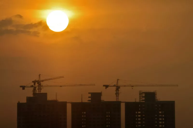Construction sites of commercial buildings are seen as the sun sets in Colombo, Sri Lanka, 24 April 2024 (Photo: Dinuka Liyanawatte/Reuters).