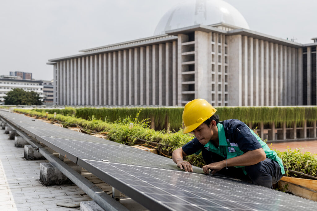 A worker inspects the solar panel system that is providing partial electrical power to Istiqlal Mosque in Jakarta, Indonesia, 3 May 2024 (Photo: NurPhoto via Reuters/Garry Lotulung).