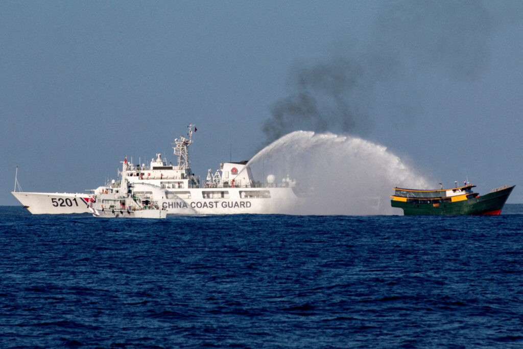 Chinese Coast Guard vessels fire water cannons towards a Philippine resupply vessel, Second Thomas Shoal, South China Sea, 5 March 2024 (Photo: Reuters/Adrian Portugal).