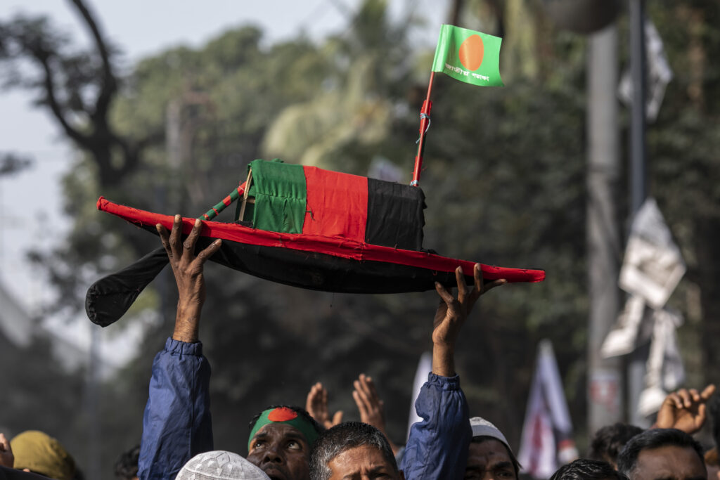 A supporter of Bangladesh's ruling Awami League party is seen carrying the party's election symbol boat on his head as he arrives at Suhrawardy Udyan to attend a public rally. (Photo: REUTERS/Sazzad Hossain / SOPA Images/Sipa USA)