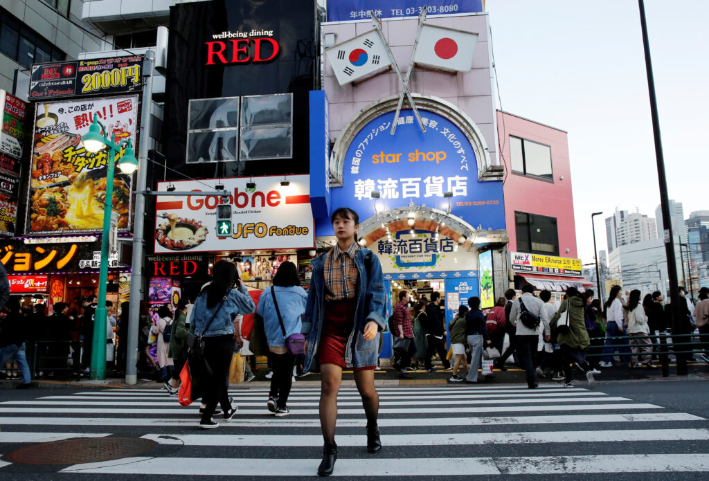 Nao Niitsu, a college freshman from Tokyo, walks through Shin-Okubo district, which is known as Tokyo's Korea Town, in Tokyo, Japan, 21 March 2019.