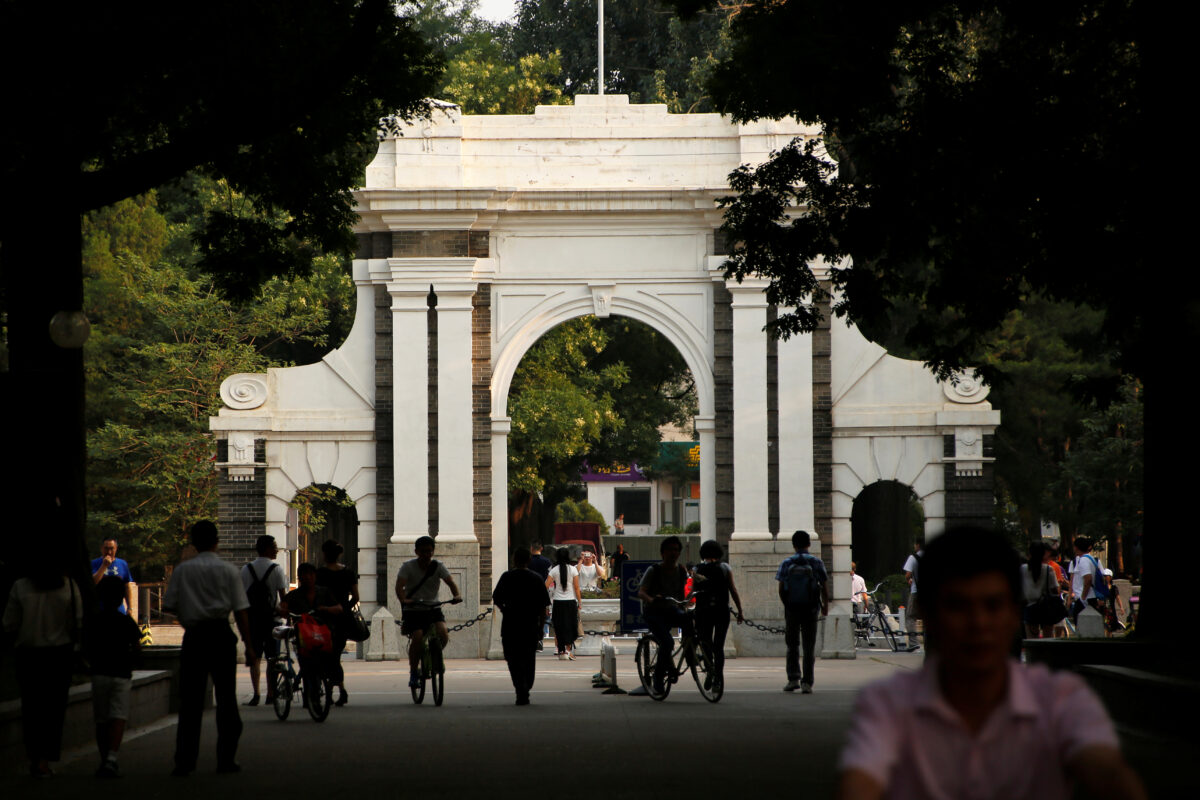 People walk near the gate of Tsinghua University in Beijing, China, 27 July 2016